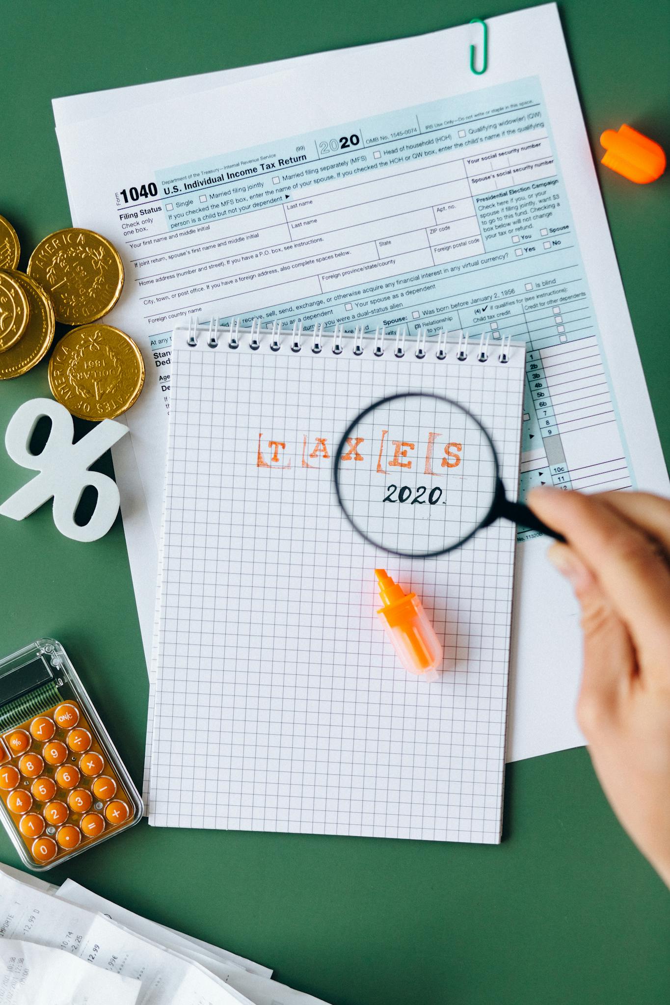 a tax themed composition featuring forms a magnifying