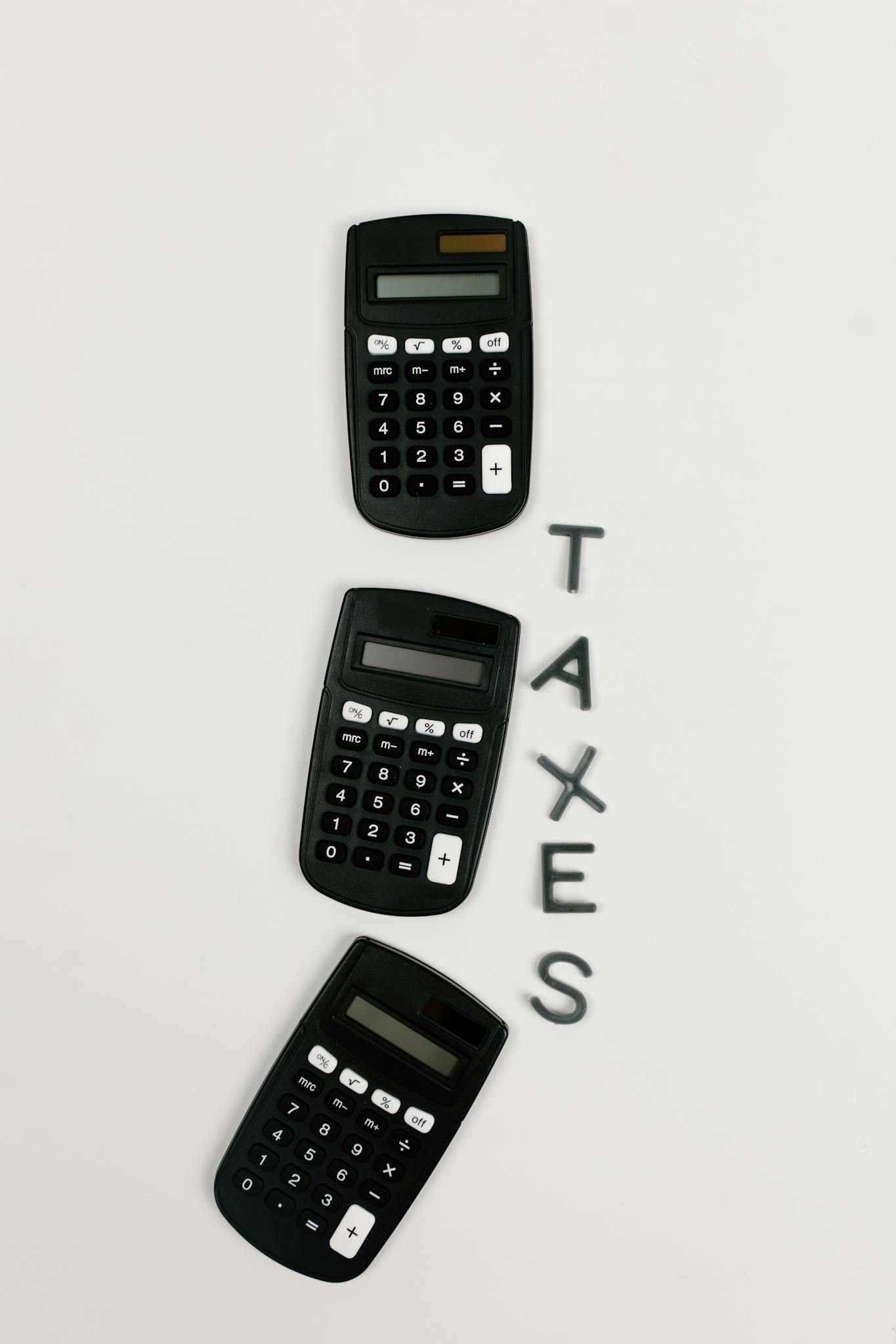 flat lay of three calculators with