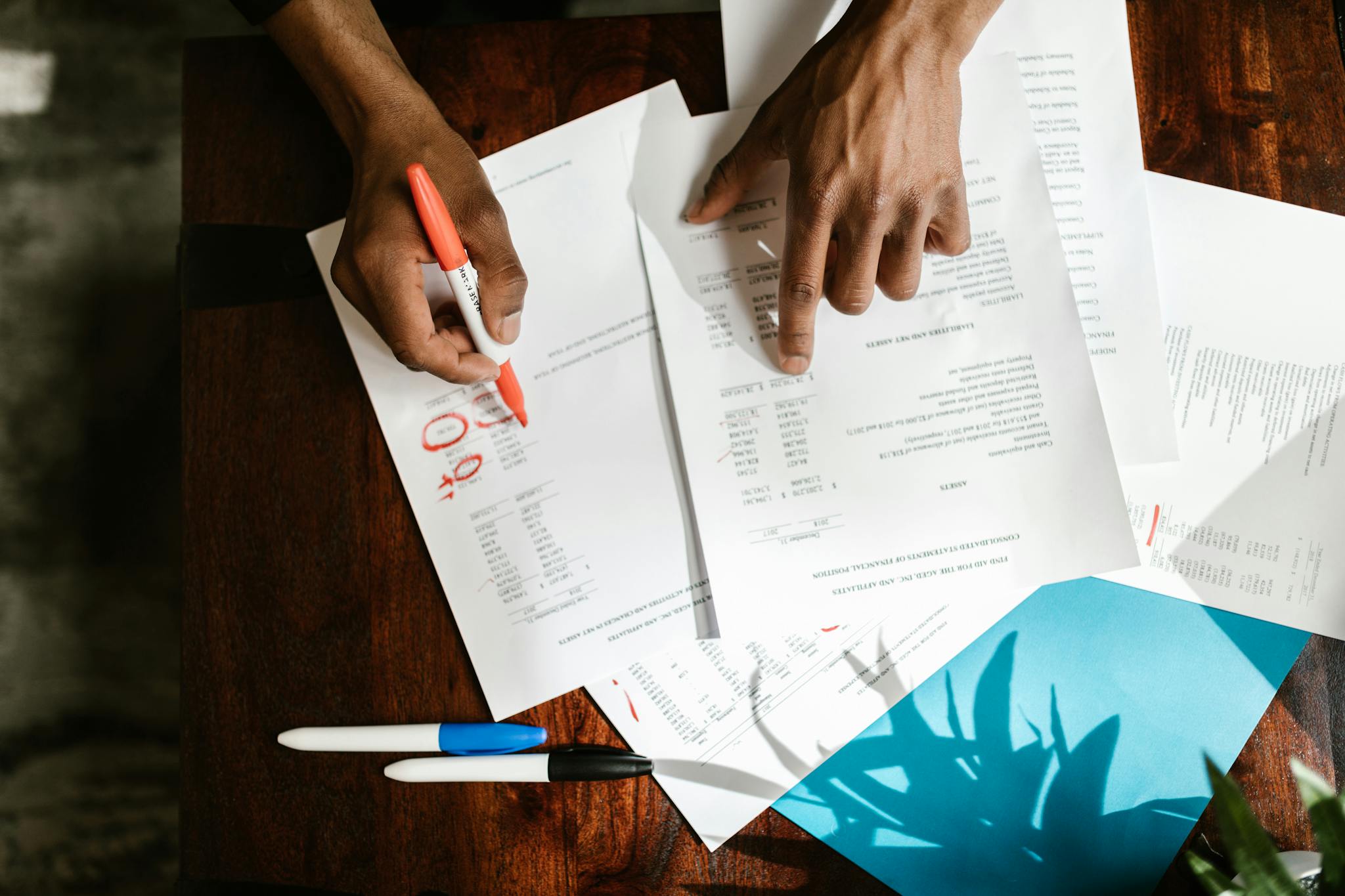 overhead view of hands highlighting financial documents